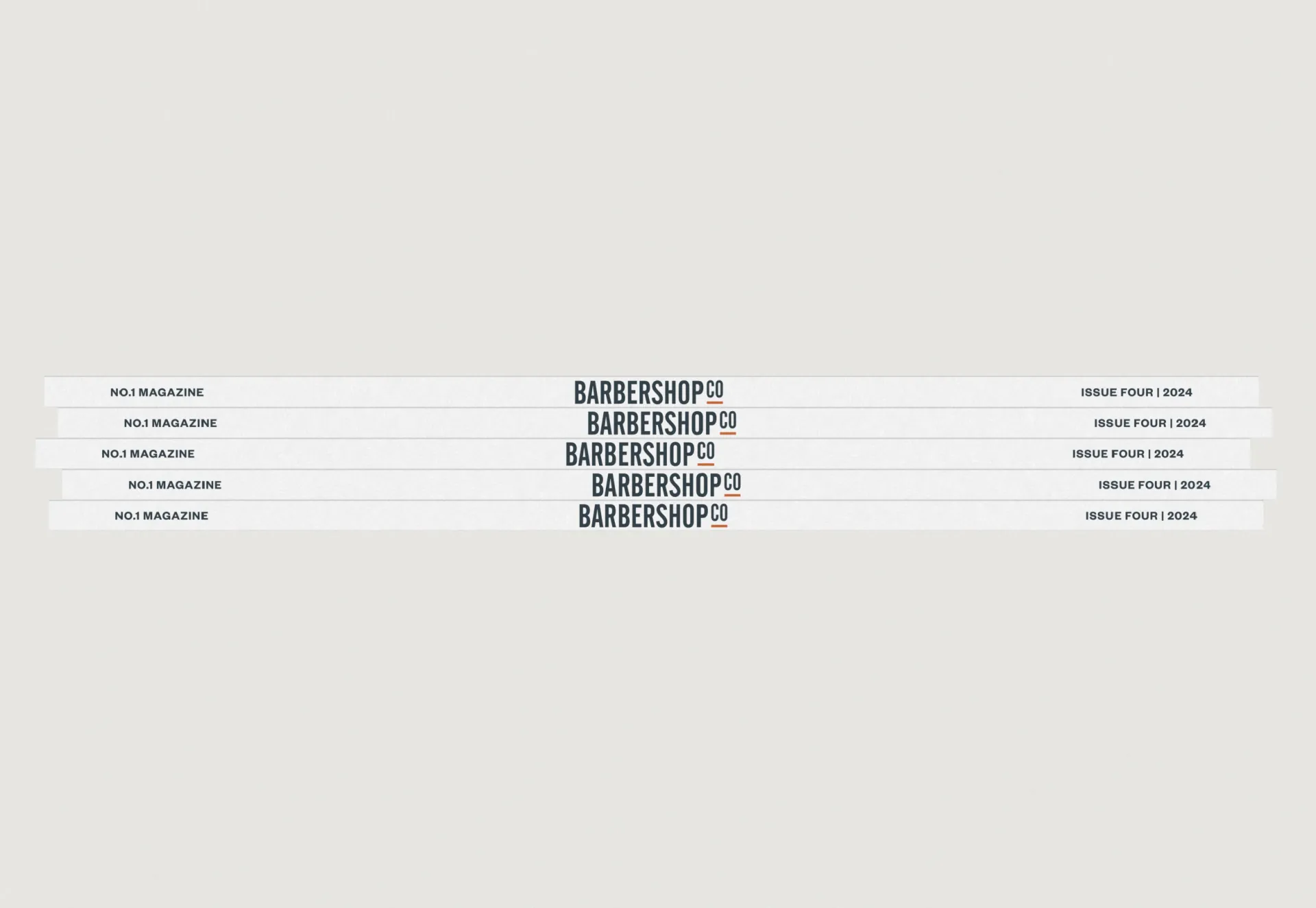 Five copies of the magazine stacked, their spines reading No.1 Magazine, BarberShopCo, Issue Four 2024.