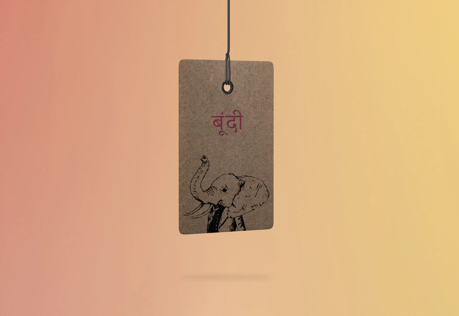 A kraft Satya swing tag with the elephant illustration and Hindi lettering.