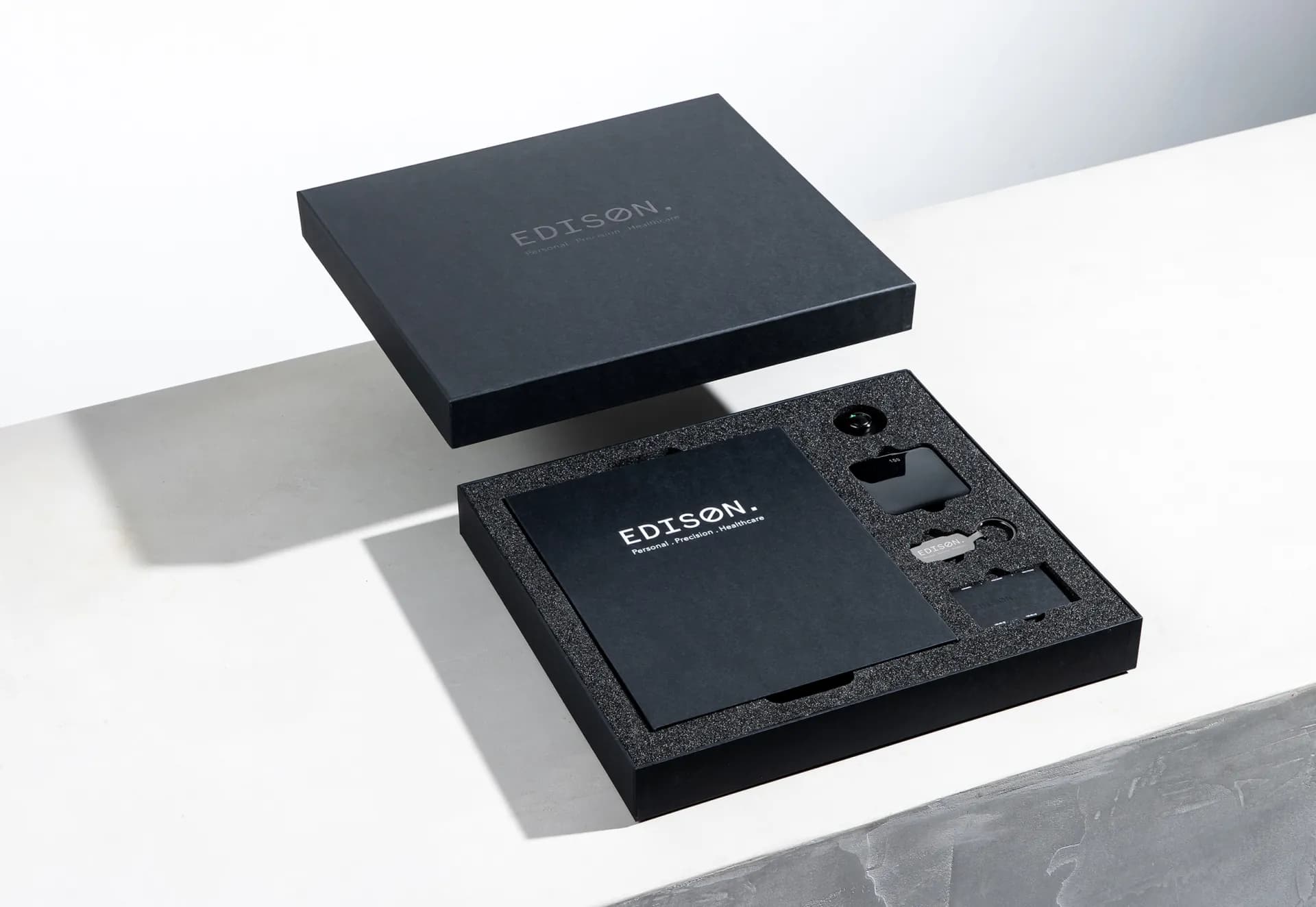 The Edison Members Kit open, its lid lifted and the contents set into black foam.