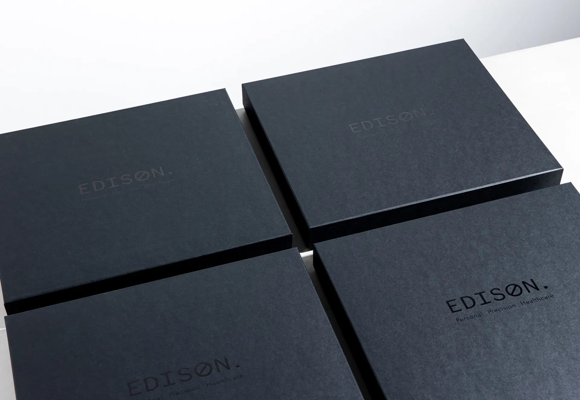 Four black Edison box lids side by side.