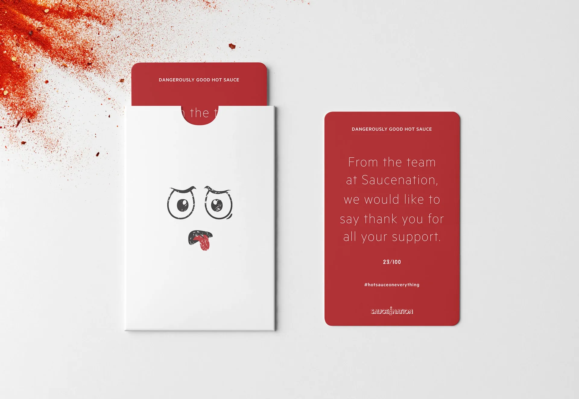 A SauceNation thank-you card beside its white sleeve, the SauceNation face on the front.